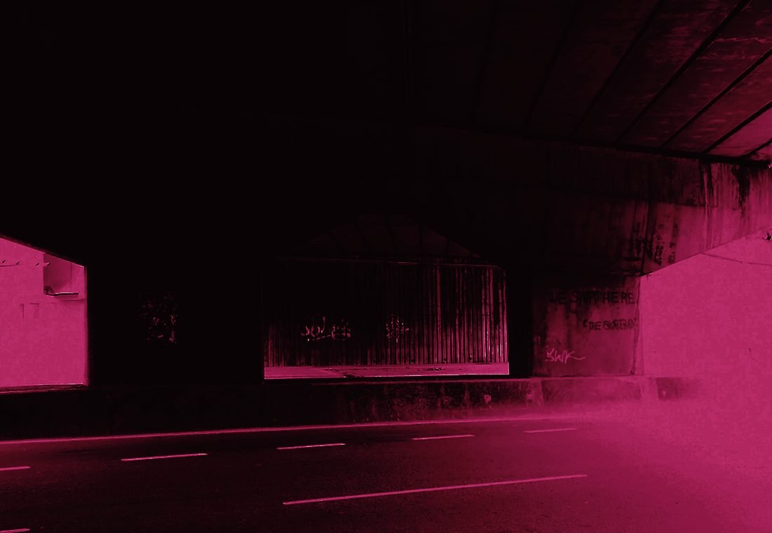 An empty underpass, light at both ends